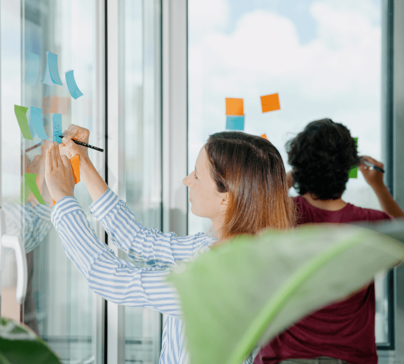 People writing on Post-Its