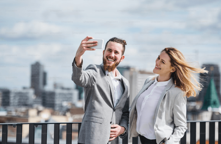 Two people taking a selfie on a roof.